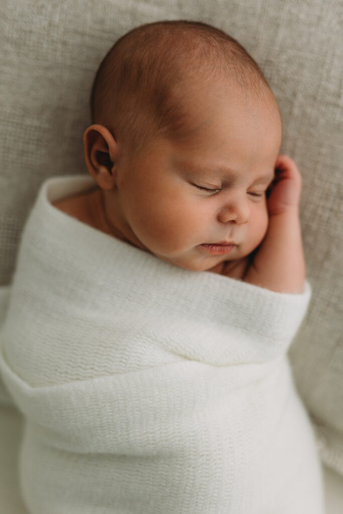 Newborn baby picture in Kelowna B.C. with baby sleeping in a white blanket